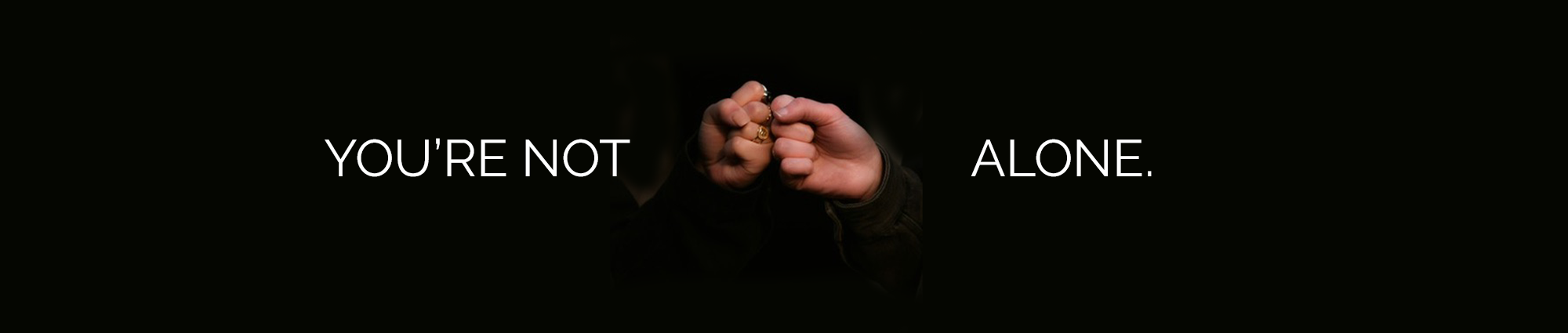 Two hands fist-pumping with caption, "You're Not Alone."
