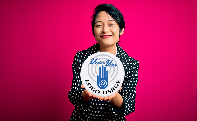 Woman on pink background holding round sign that reads, Logo Usage"